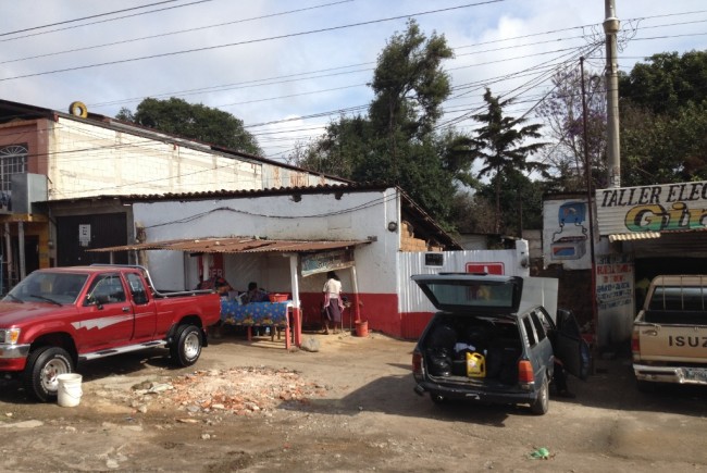 Washing a truck outside a small restaurant